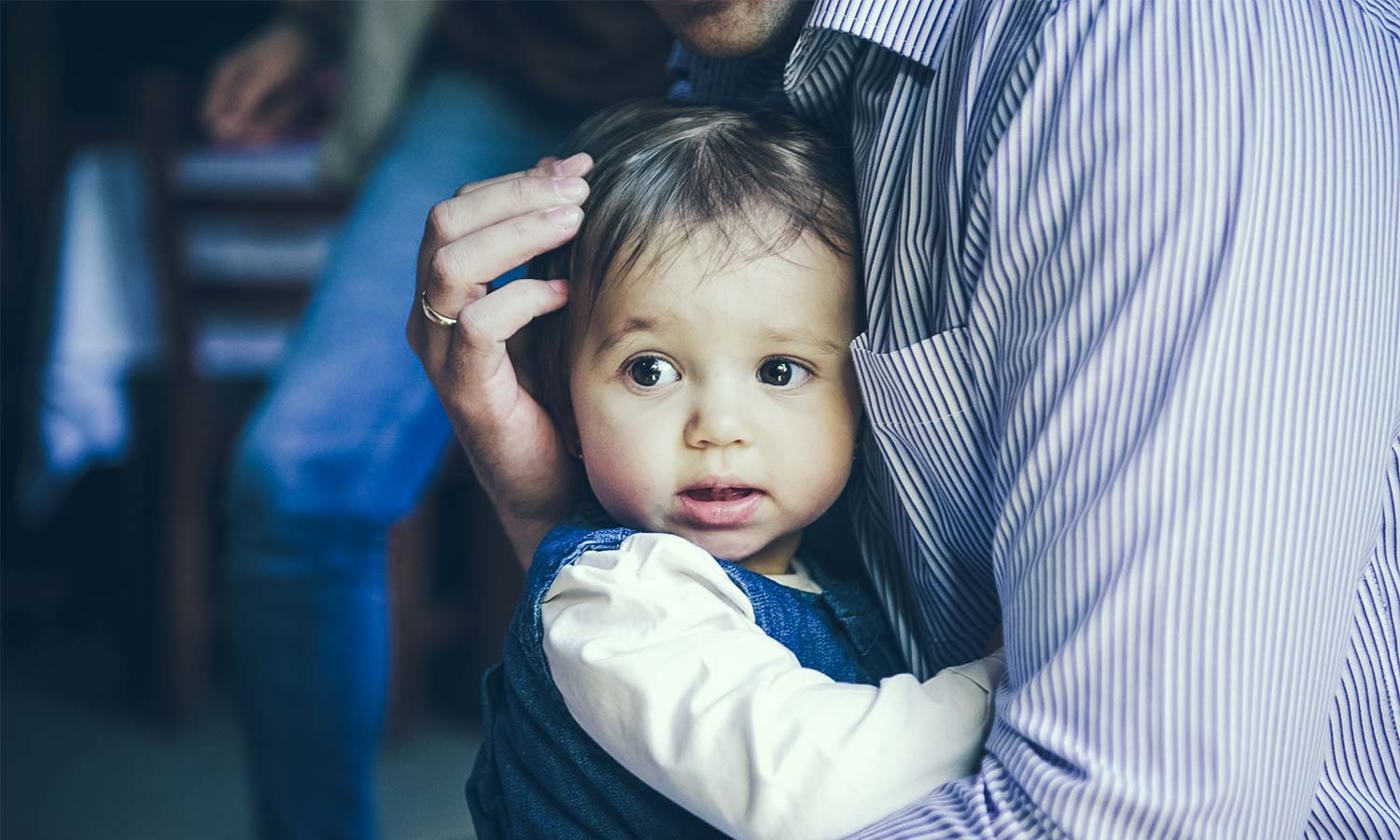 Child clinging to parent