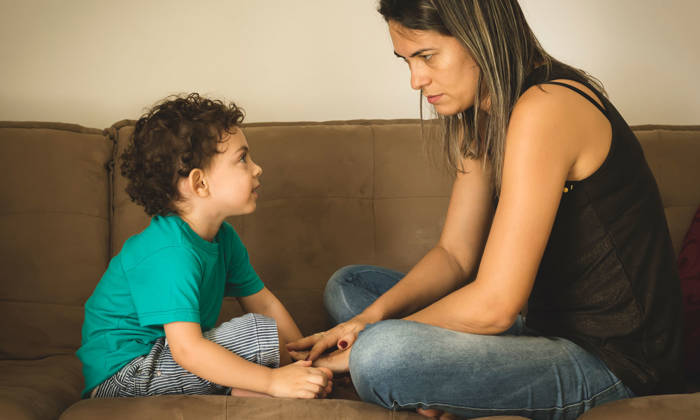 Mother speaking seriously to her son