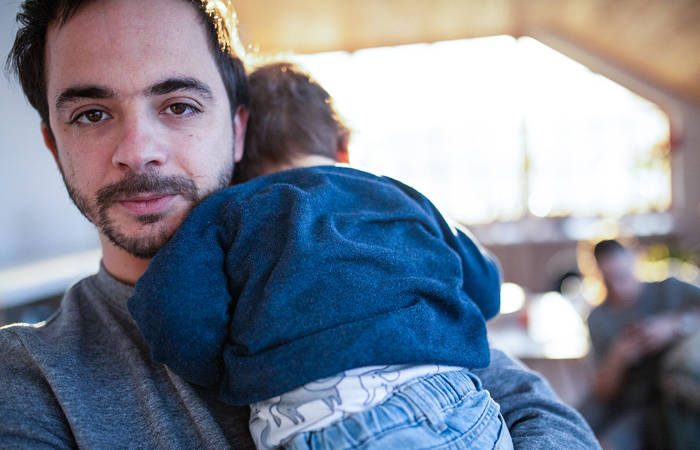 Adult man holding baby boy