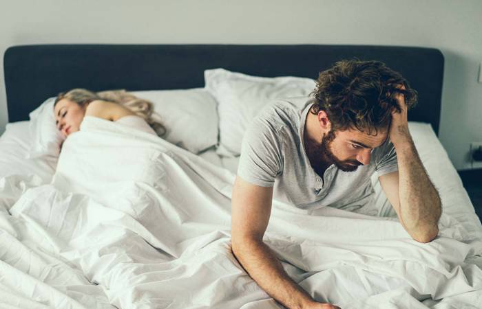 Tired man waking up in the morning