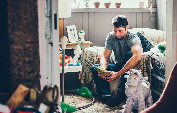 Sad father in a nursery