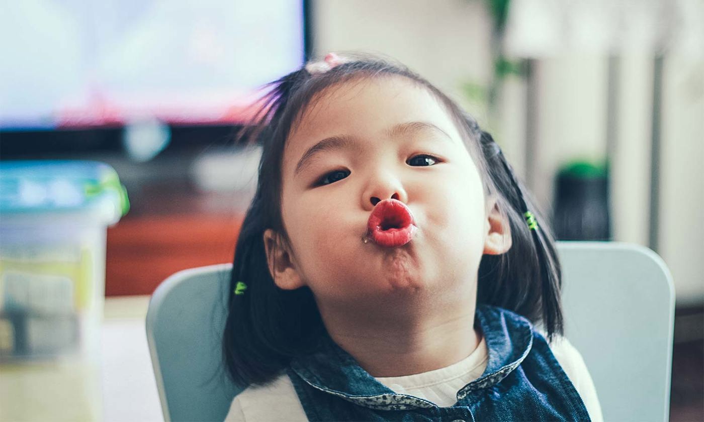 Toddler girl pulling faces
