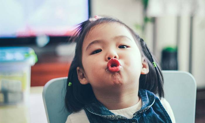 Toddler girl pulling faces