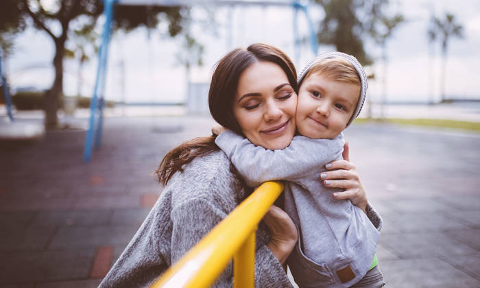 Mum gives a hug to her young son