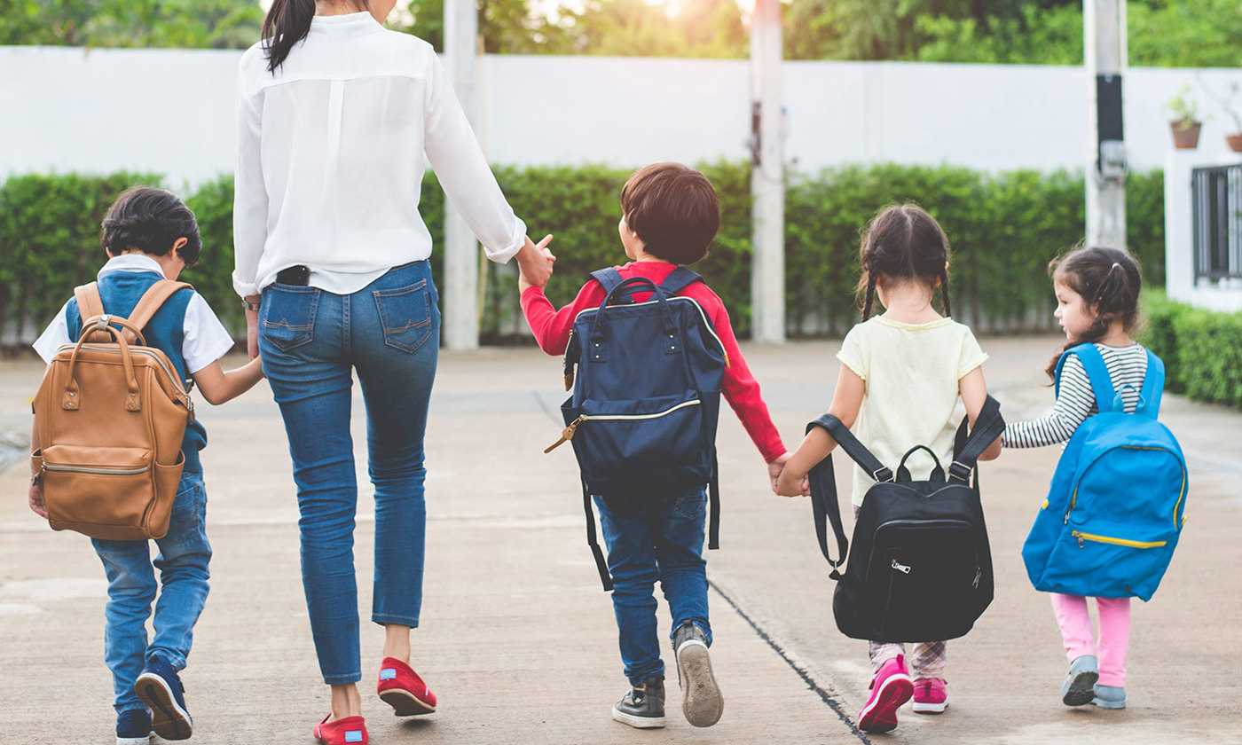 Mother with children going to school and preschool