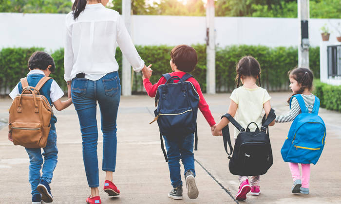 Mother with children going to school and preschool