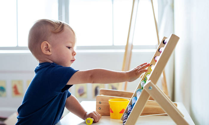 Little boy playing with an abacus
