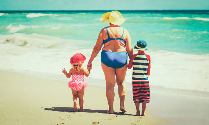 Grandmother with grandchildren at the beach