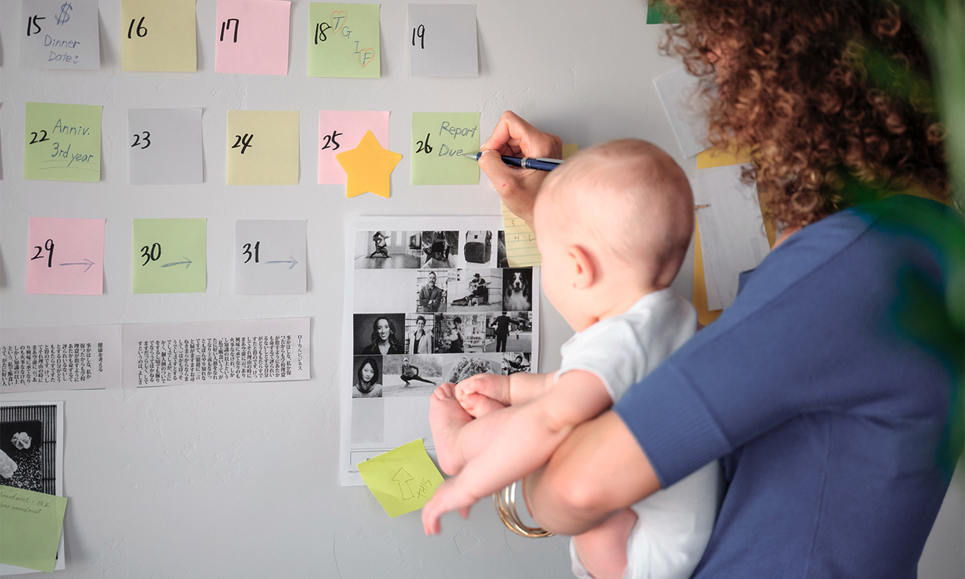 Working mother balancing baby