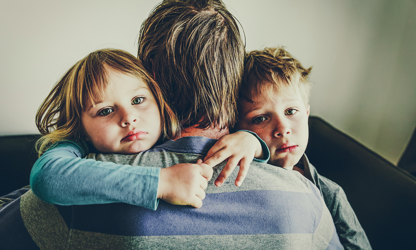 Sad and worried boy and girl with father