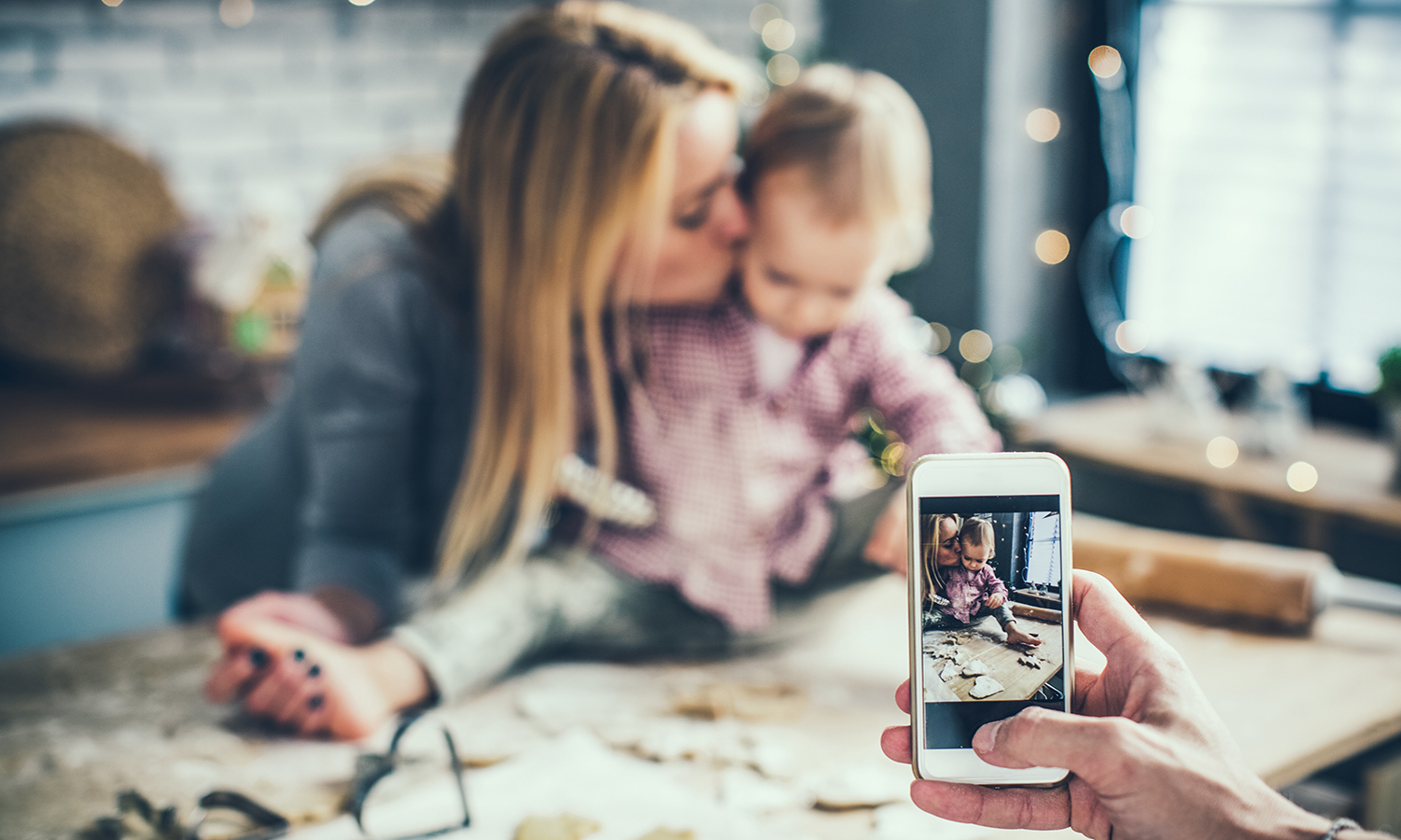 Taking a photo of mother and child