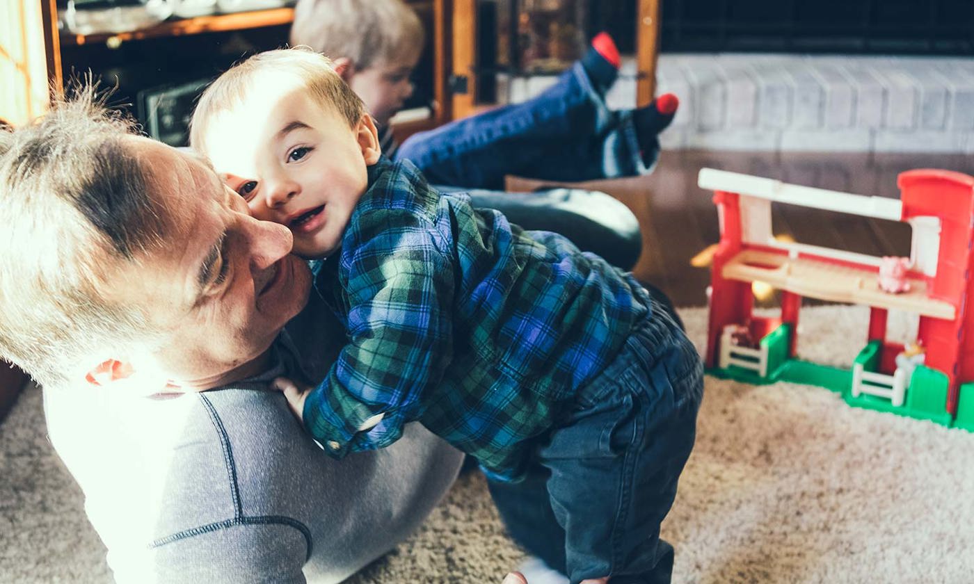 Elderly man playing with small children