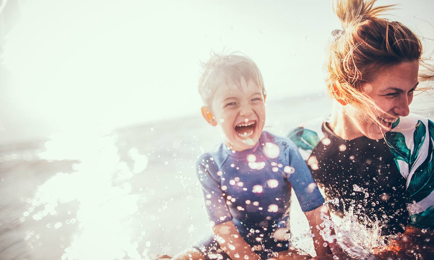 Mother and son enjoy sea water
