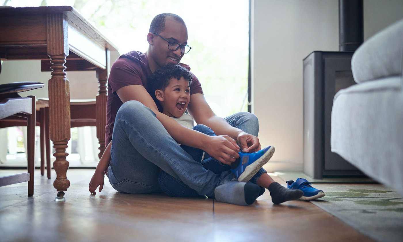 Dad helping tie son's shoes