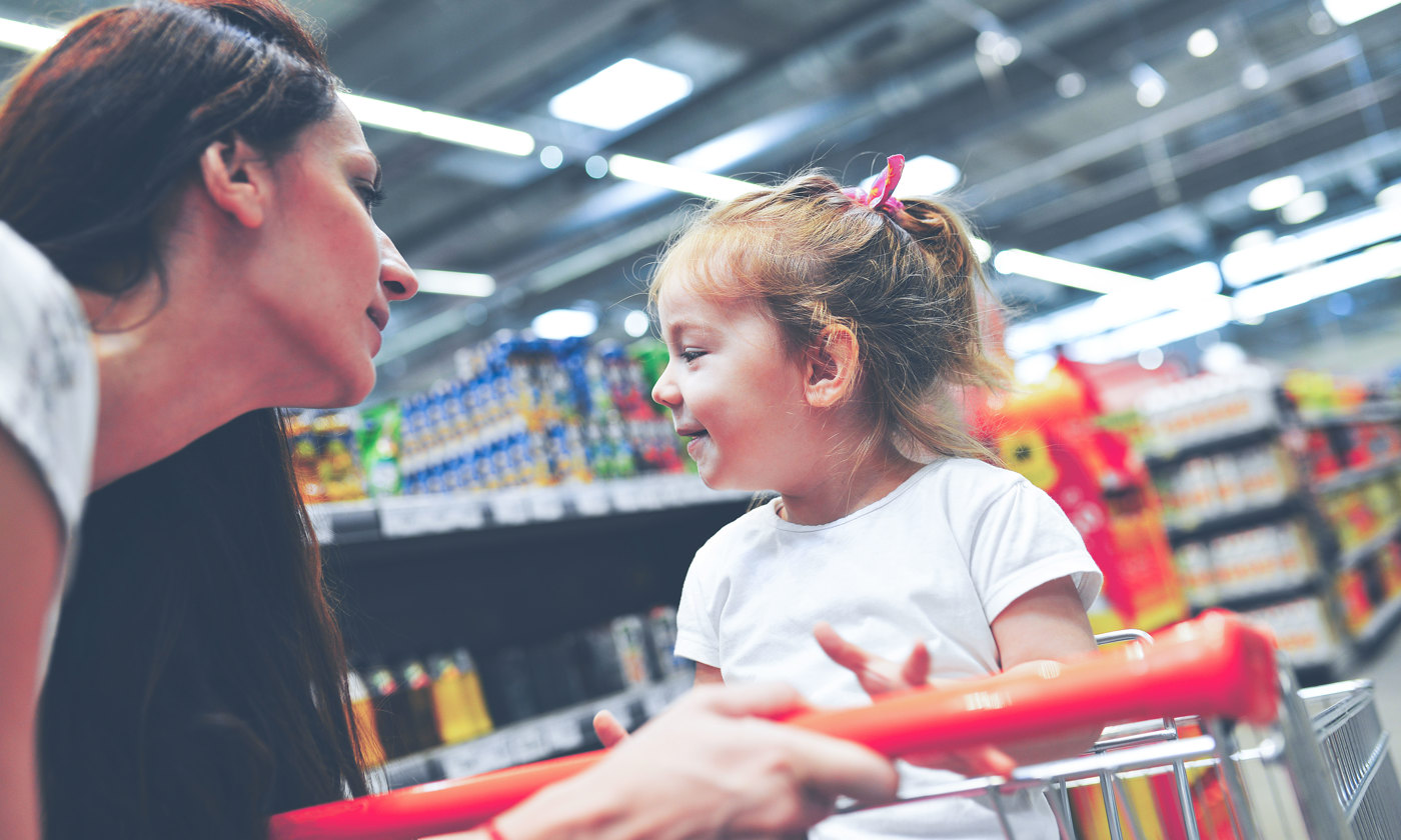Child having an argument with mother at candy counter