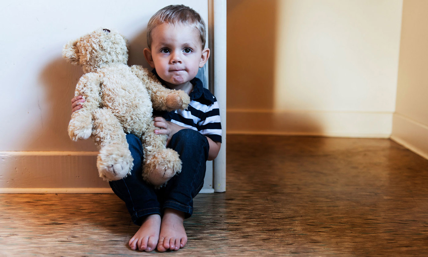 Upset child sitting on the floor