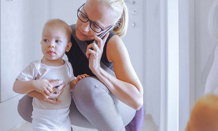 Young mother with baby on the phone