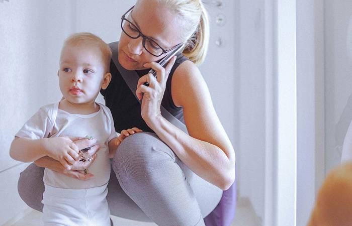 Young mother with baby on the phone