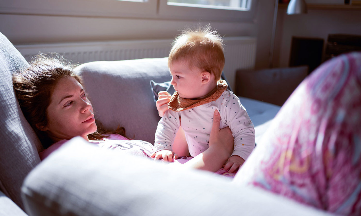 Tired mother with baby