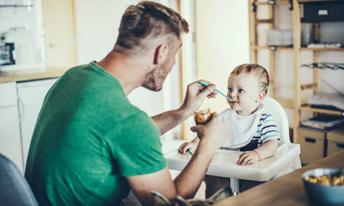 Father feeding an infant