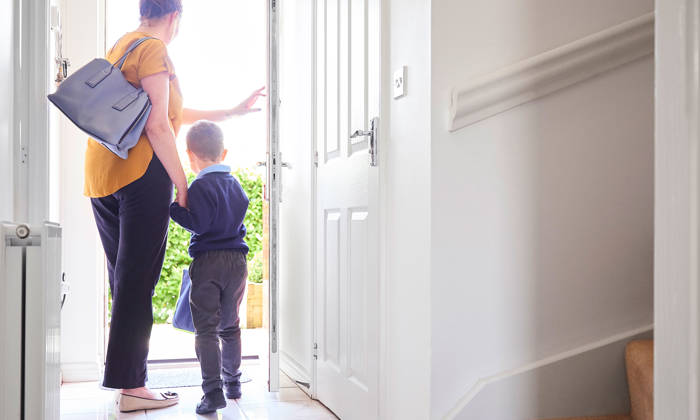 A mother and son on their way out for his first day at school