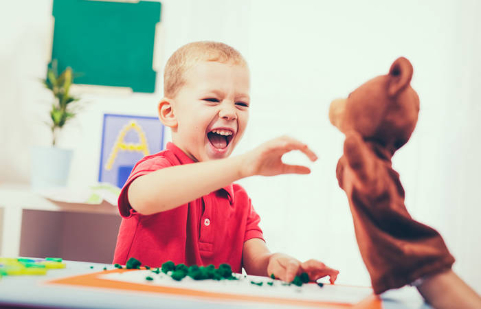 Little boy during lesson with his speech therapist
