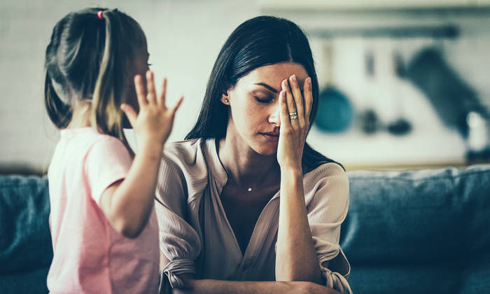 Tired mother with upset daughter