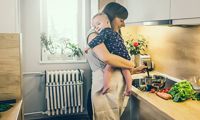 Mum cooking in the kitchen with a baby