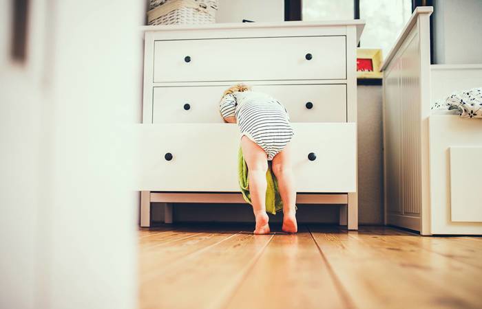 Toddler boy in a dangerous situation at home