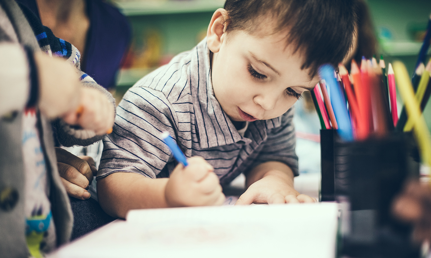 Boy drawing with color pencil
