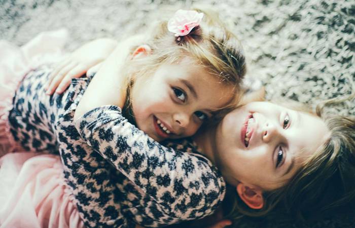 Two girls hugging on the floor