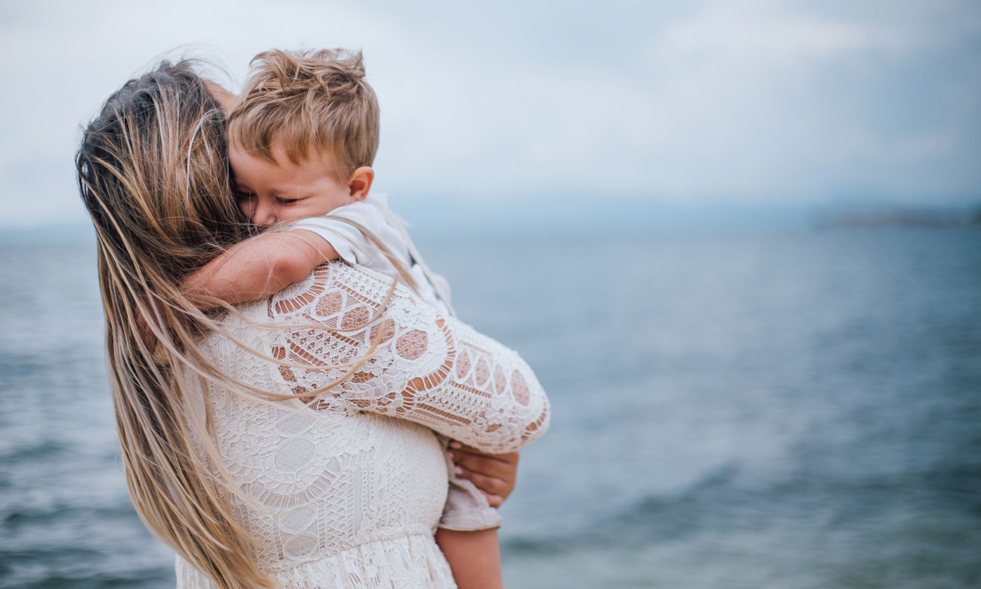 Mother hugs son