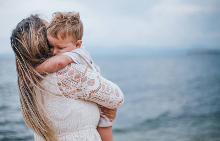 Mother hugs son