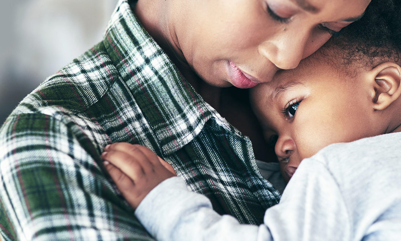 Mother cradling her little baby boy