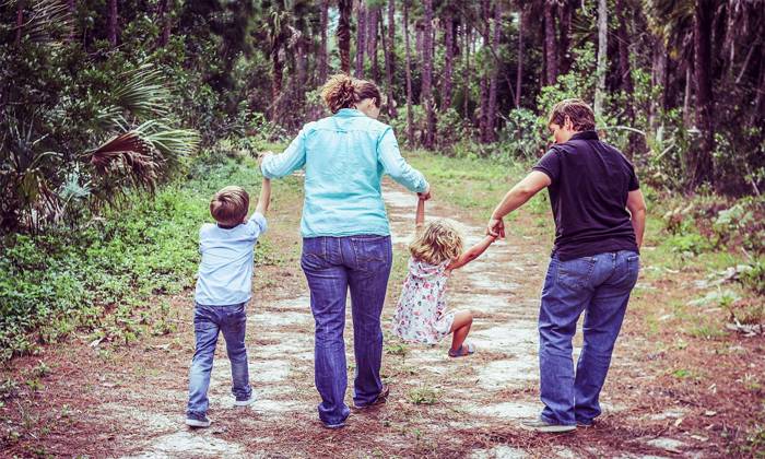 two mums walking on track with their children