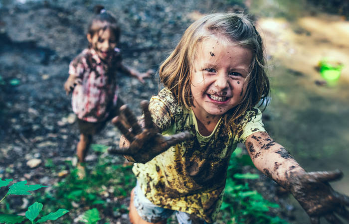 Smiling muddy little girl
