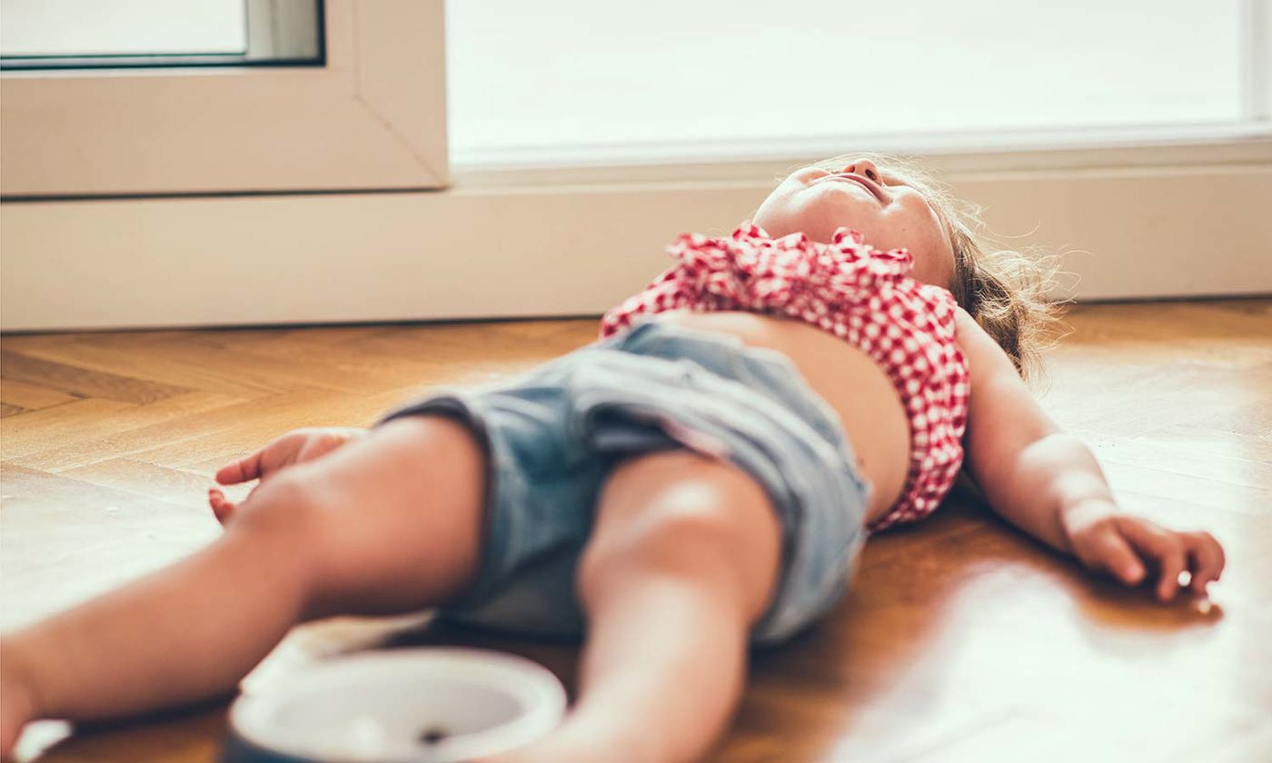 Little girl on lying on the floor