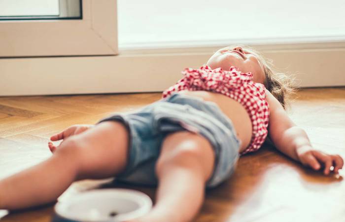 Little girl on lying on the floor